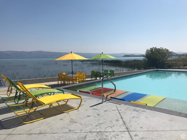 55 E Buttercup Ln Unit 42, Garden City, UT 84028 - pool featuring a patio and a mountain view
