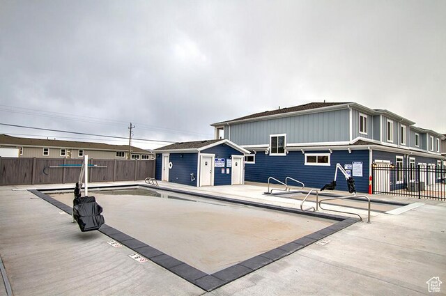 55 E Buttercup Ln Unit 42, Garden City, UT 84028 - rear view of property with a patio, a community pool, and fence
