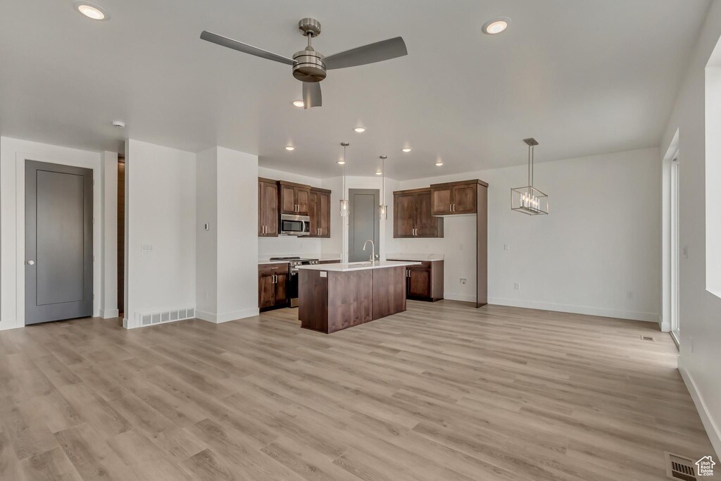 1323 N 1440 E Unit 7, Payson, UT 84651 - kitchen with stainless steel appliances, light countertops, baseboards, open floor plan, and ceiling fan