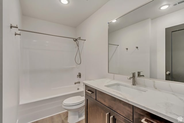 bathroom featuring wood finished floors, visible vents, shower / bath combination, toilet, and vanity
