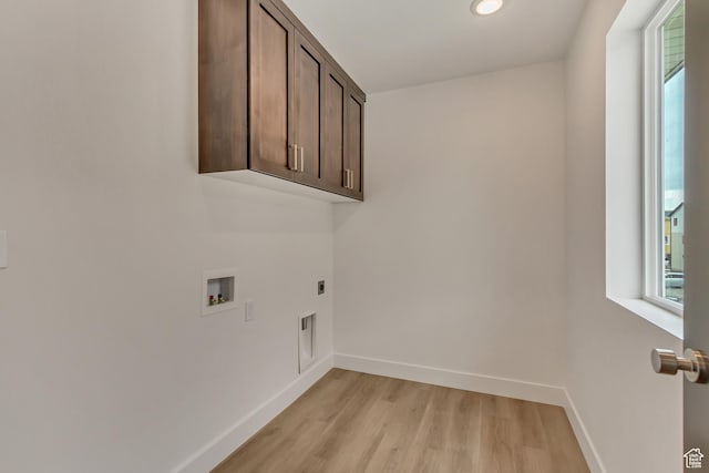 washroom with baseboards, light wood-style floors, washer hookup, cabinet space, and electric dryer hookup