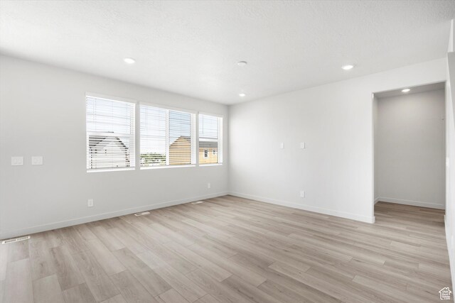 1345 N Harper Way Unit 0250, Tooele, UT 84074 - spare room with light wood-style floors and recessed lighting