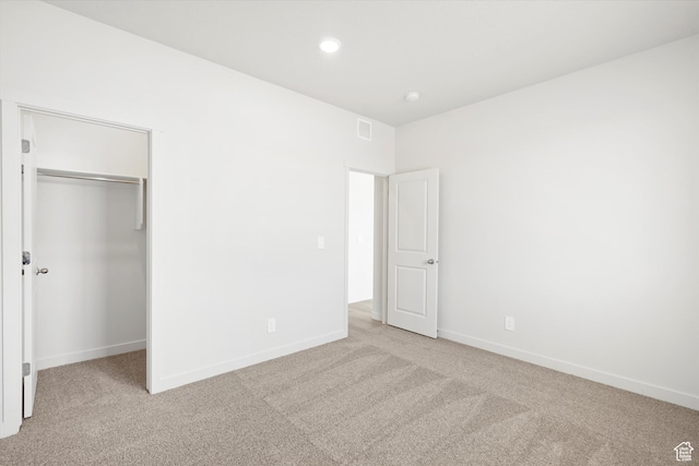 1345 N Harper Way Unit 0250, Tooele, UT 84074 - unfurnished bedroom with light carpet, a spacious closet, a closet, and recessed lighting