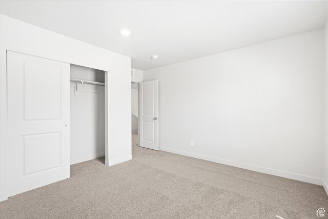 1345 N Harper Way Unit 0250, Tooele, UT 84074 - unfurnished bedroom featuring light colored carpet, a closet, and recessed lighting