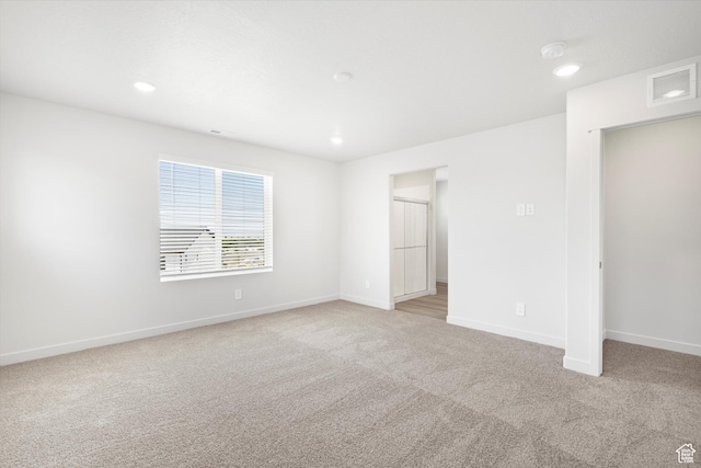 1345 N Harper Way Unit 0250, Tooele, UT 84074 - unfurnished bedroom featuring light colored carpet and recessed lighting