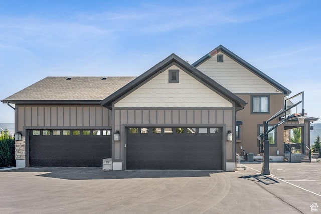 2154 E 1340 S, Heber City, UT 84032 - view of front facade with central air condition unit, board and batten siding, driveway, and a garage