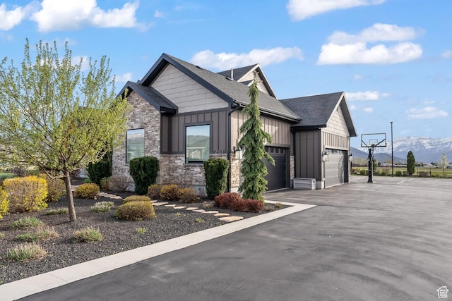 2154 E 1340 S, Heber City, UT 84032 - view of property exterior featuring board and batten siding, a mountain view, stone siding, an attached garage, and driveway