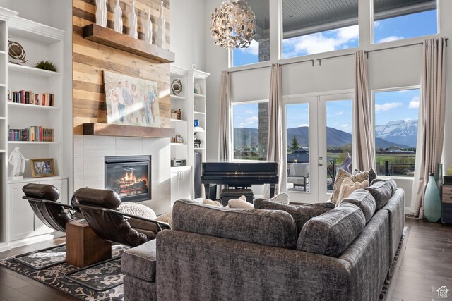 2154 E 1340 S, Heber City, UT 84032 - living area featuring built in shelves, hardwood / wood-style floors, a towering ceiling, and a fireplace