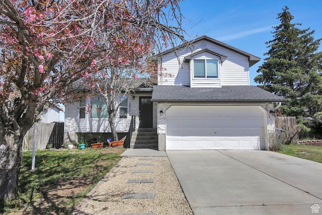 view of front of property featuring an attached garage, fence, a shingled roof, and driveway