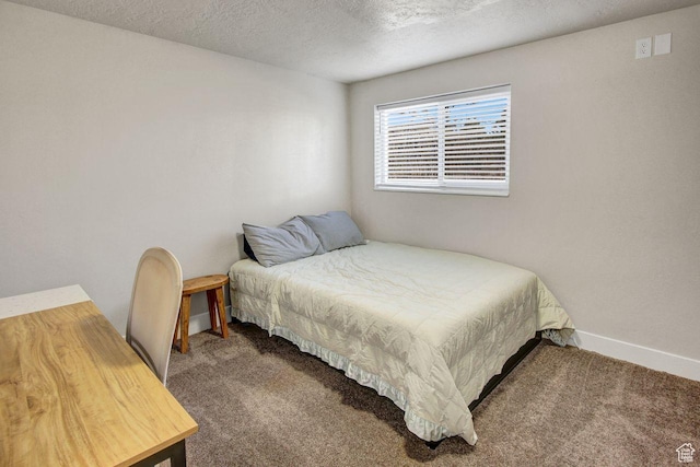 carpeted bedroom featuring a textured ceiling and baseboards