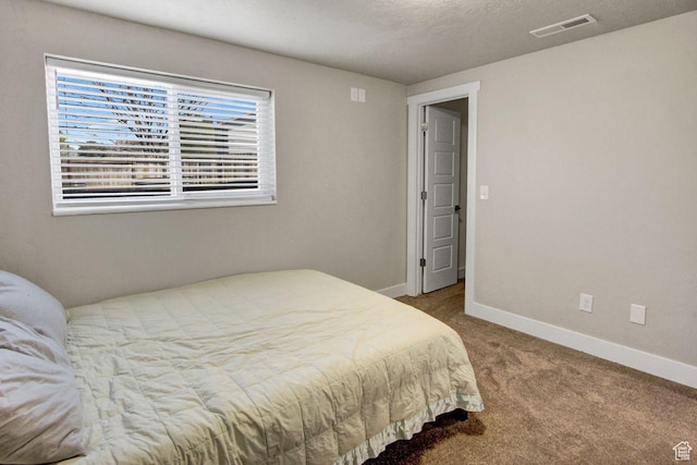 bedroom featuring baseboards, carpet, and visible vents