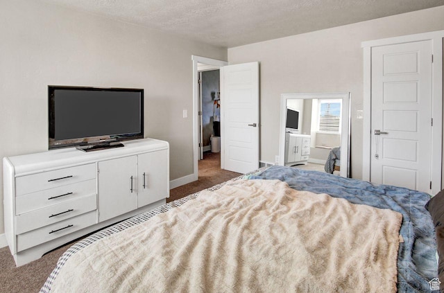 carpeted bedroom featuring a textured ceiling and baseboards
