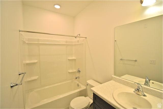 full bath featuring vanity, toilet, and shower / washtub combination