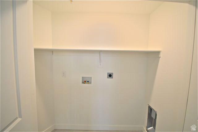 clothes washing area featuring hookup for an electric dryer and hookup for a washing machine