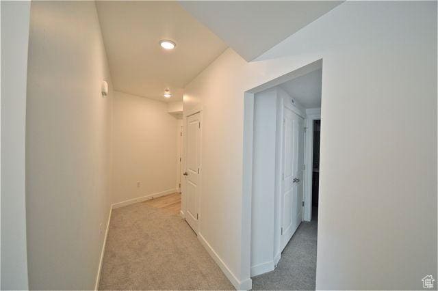 hallway featuring recessed lighting, carpet flooring, and baseboards