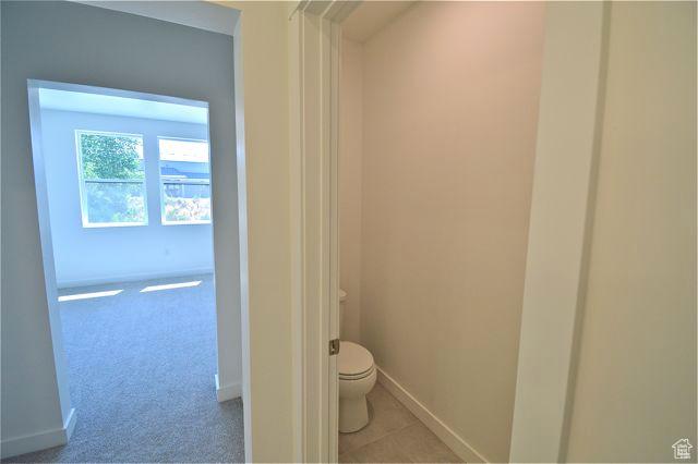 bathroom featuring toilet and baseboards
