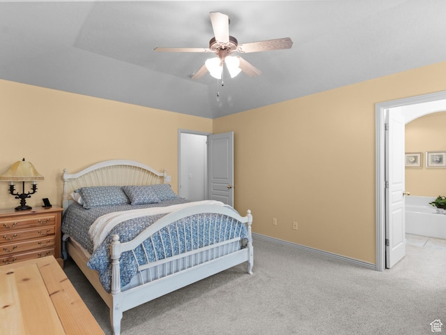 carpeted bedroom with baseboards, a ceiling fan, and connected bathroom