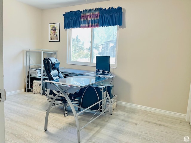 office area featuring baseboards and wood finished floors