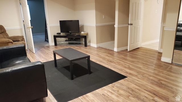 living room with baseboards and wood finished floors