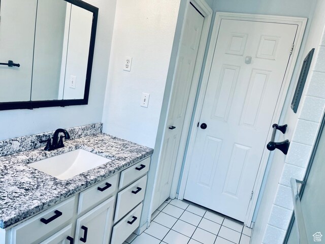 bathroom with tile patterned floors and vanity