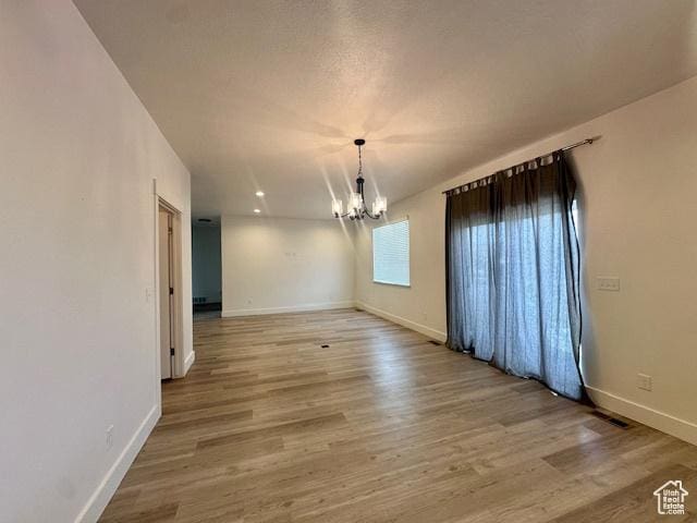 122 W 930 S, Tremonton, UT 84337 - unfurnished dining area featuring baseboards, an inviting chandelier, and wood finished floors