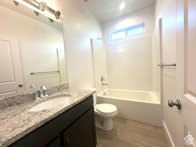 122 W 930 S, Tremonton, UT 84337 - full bath with toilet, shower / bathing tub combination, vanity, and wood finished floors