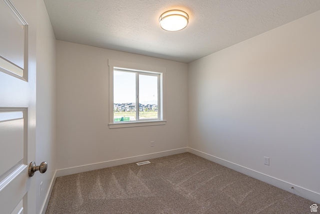 1038 W 2260 S Unit 105, Nibley, UT 84321 - spare room featuring dark colored carpet and a textured ceiling