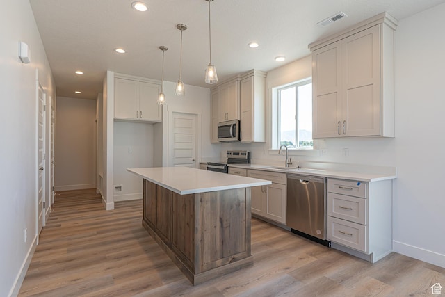 1038 W 2260 S Unit 105, Nibley, UT 84321 - kitchen featuring stainless steel appliances, light countertops, recessed lighting, and light wood finished floors