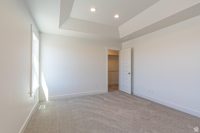 1038 W 2260 S Unit 105, Nibley, UT 84321 - unfurnished bedroom featuring carpet floors, recessed lighting, a walk in closet, and a tray ceiling