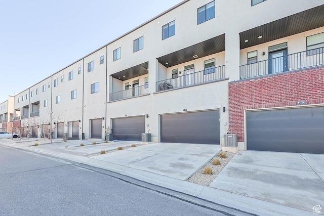25 E Center Unit 10, North Salt Lake, UT 84054 - view of property featuring a garage, central AC unit, and driveway