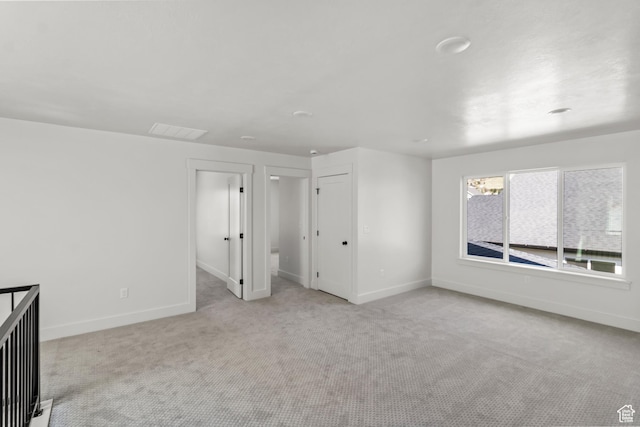 unfurnished bedroom with carpet, visible vents, and baseboards