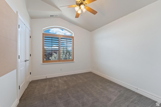 spare room with vaulted ceiling, a ceiling fan, baseboards, carpet flooring, and visible vents