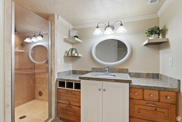 bathroom with vanity, a textured ceiling, a shower stall, and ornamental molding