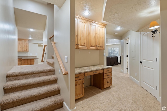staircase featuring recessed lighting, carpet floors, a textured ceiling, and baseboards