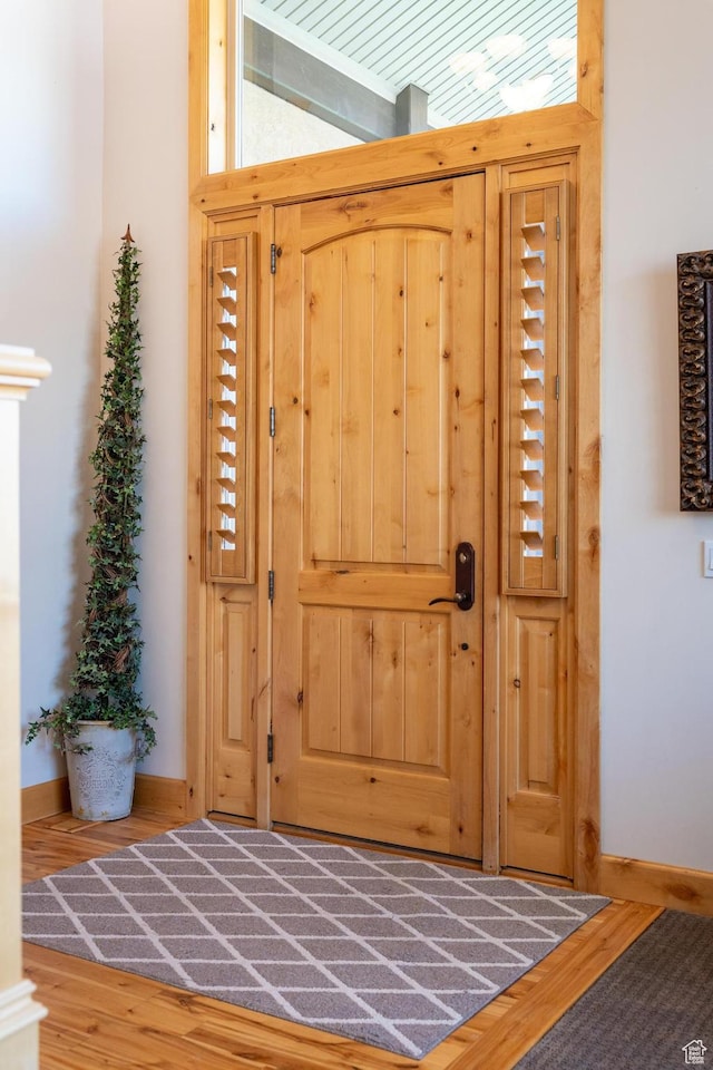 interior space featuring baseboards and wood finished floors