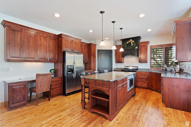 kitchen featuring a center island, open shelves, stainless steel appliances, and light wood-style floors