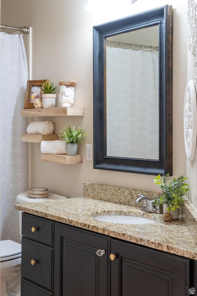 full bath featuring vanity and toilet