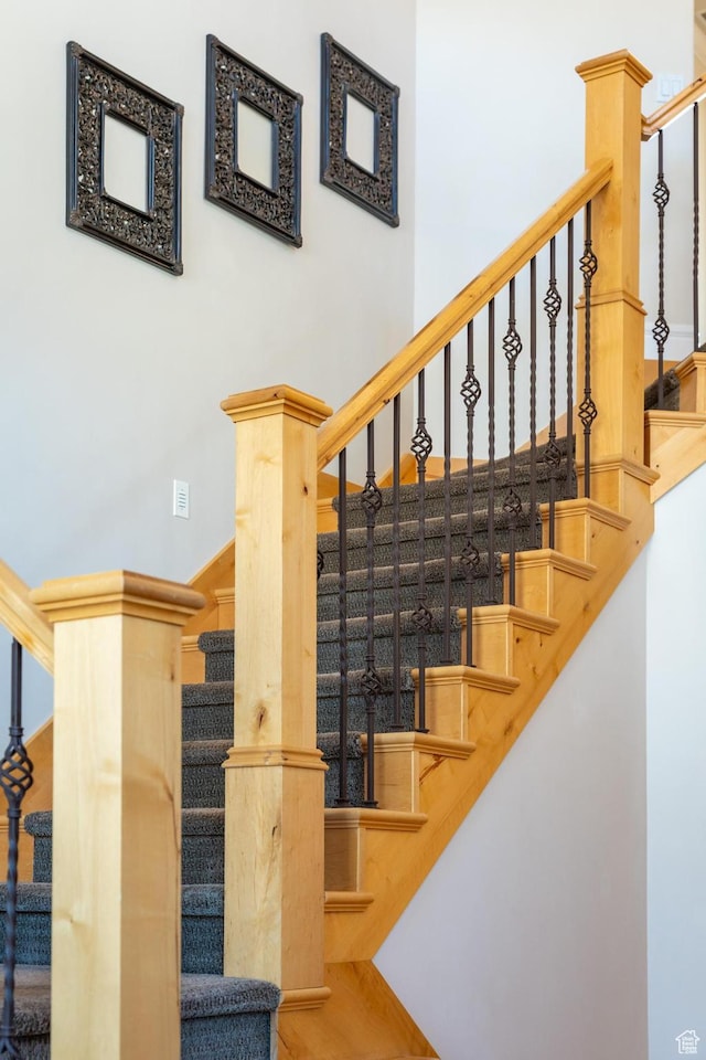 staircase featuring a high ceiling