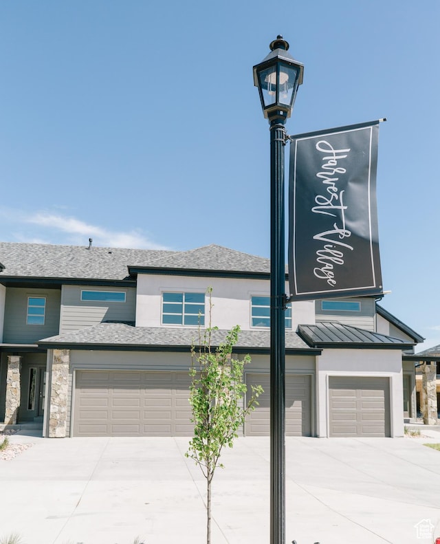 174 W Autumn Ln N Unit 138, Saratoga Springs, UT 84045 - exterior details with a standing seam roof, metal roof, stone siding, and concrete driveway
