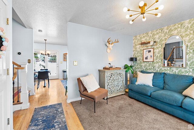 1480 W 650 S, Lehi, UT 84043 - living area featuring a notable chandelier, wallpapered walls, a textured ceiling, an accent wall, and wood finished floors