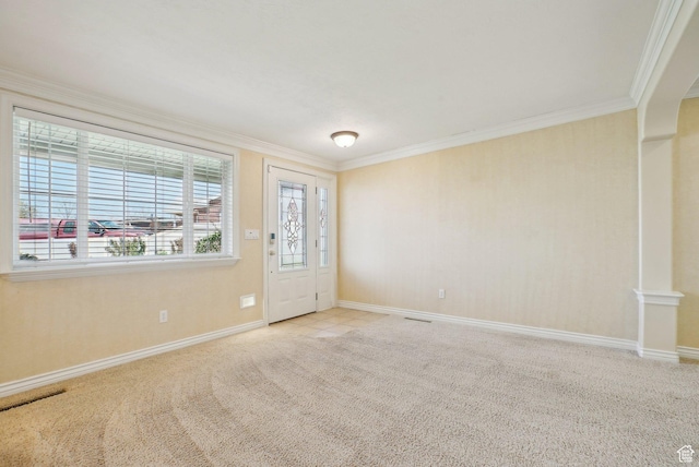 spare room featuring carpet, baseboards, and crown molding