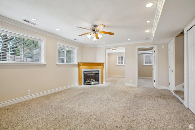unfurnished living room featuring a glass covered fireplace, plenty of natural light, visible vents, and ceiling fan