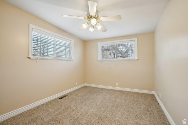 empty room with visible vents, carpet, and a healthy amount of sunlight