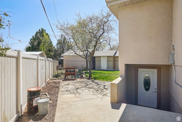 view of patio / terrace featuring fence and an outdoor structure