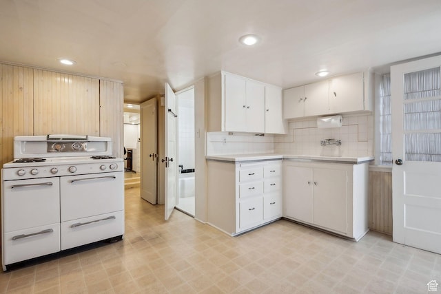 326 N Quince St, Salt Lake City, UT 84103 - kitchen with white cabinets, light countertops, recessed lighting, range with two ovens, and light floors