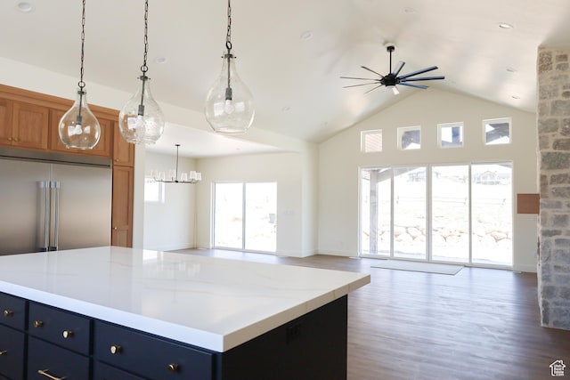 3896 N Eagle Ridge Dr Unit 61, Eden, UT 84310 - kitchen with brown cabinetry, open floor plan, wood finished floors, and ceiling fan with notable chandelier
