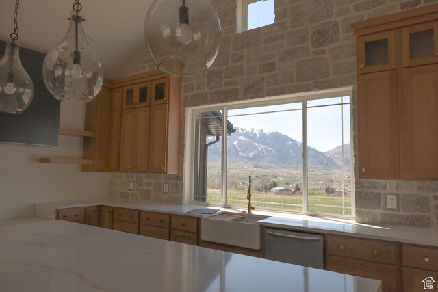3896 N Eagle Ridge Dr Unit 61, Eden, UT 84310 - kitchen with open shelves, light countertops, a sink, a mountain view, and decorative backsplash