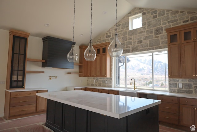 3896 N Eagle Ridge Dr Unit 61, Eden, UT 84310 - kitchen with open shelves, light countertops, vaulted ceiling, a sink, and a kitchen island