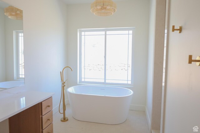 3896 N Eagle Ridge Dr Unit 61, Eden, UT 84310 - bathroom featuring baseboards, a soaking tub, tile patterned floors, and vanity