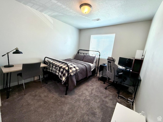 bedroom with visible vents, a textured ceiling, baseboards, and carpet floors